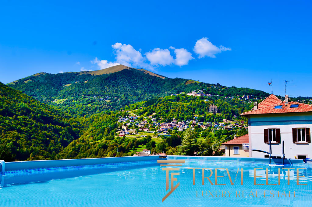Современная недвижимость в горах с бассейном, панорамный вид на зеленые холмы и уютный дом. Идеальное место для отдыха и жизни в окружении природы.