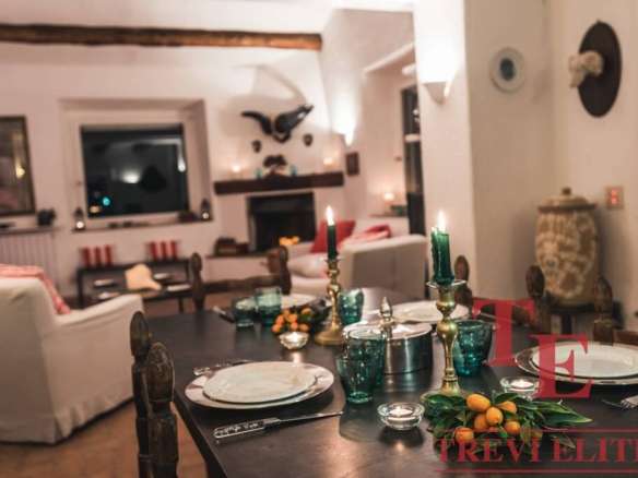 Роскошная уютная гостиная с камином, мягкими диванами и стильным декором, создающая атмосферу высокой эстетики и комфорта в элитном доме за границей.