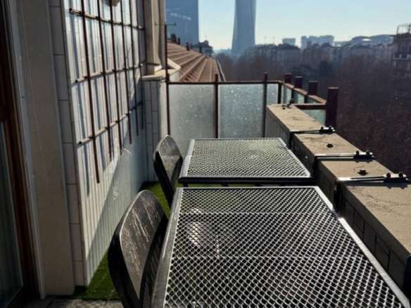 Роскошный балкон с видом на городские небоскребы в Москве, уютная зона отдыха в современном стиле, идеально подходит для высококлассной недвижимости и ценителей элитной жизни.