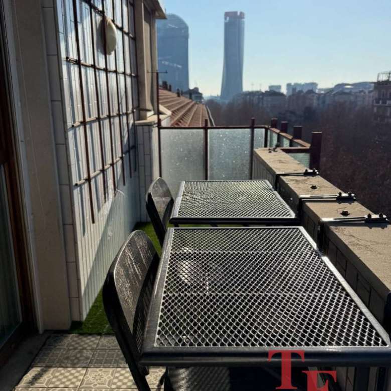 Роскошный балкон с видом на городские небоскребы в Москве, уютная зона отдыха в современном стиле, идеально подходит для высококлассной недвижимости и ценителей элитной жизни.