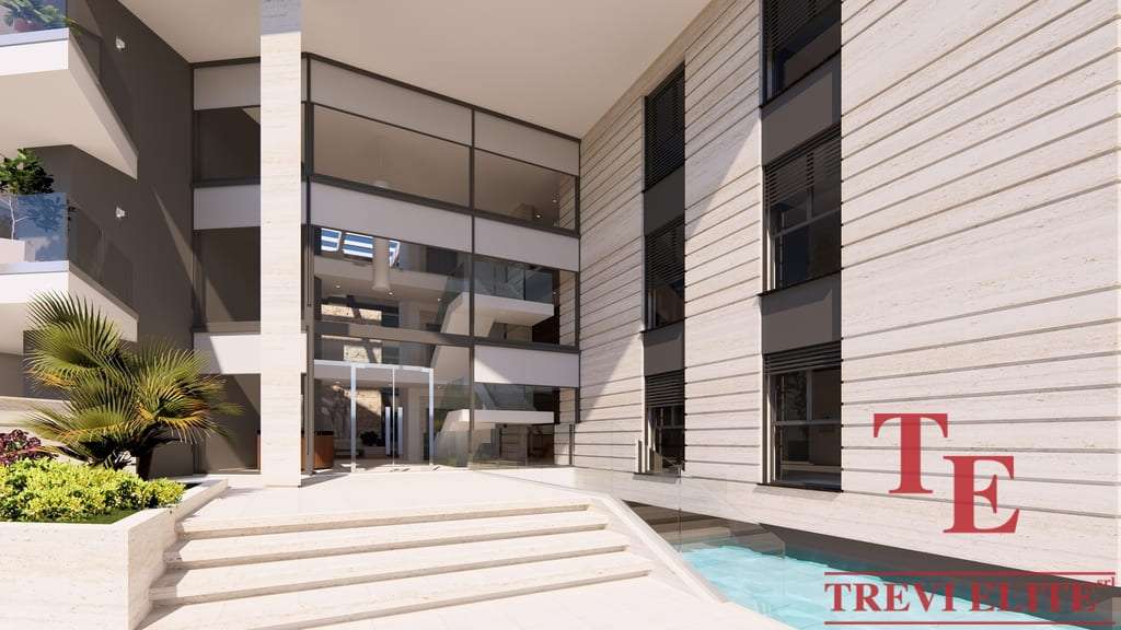 Элитное современное жилое здание с просторным входом и зоной отдыха на открытом воздухе в стиле люкс.