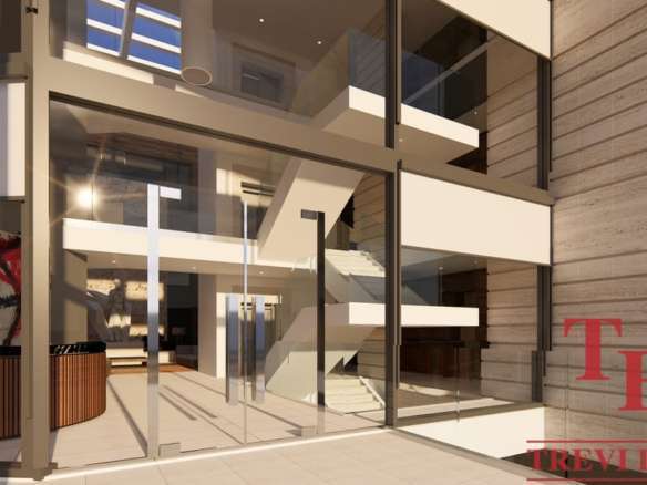 Просторный современный интерьер элитного жилого комплекса с панорамными окнами и стильным дизайном, идеально подходящий для роскошной жизни.