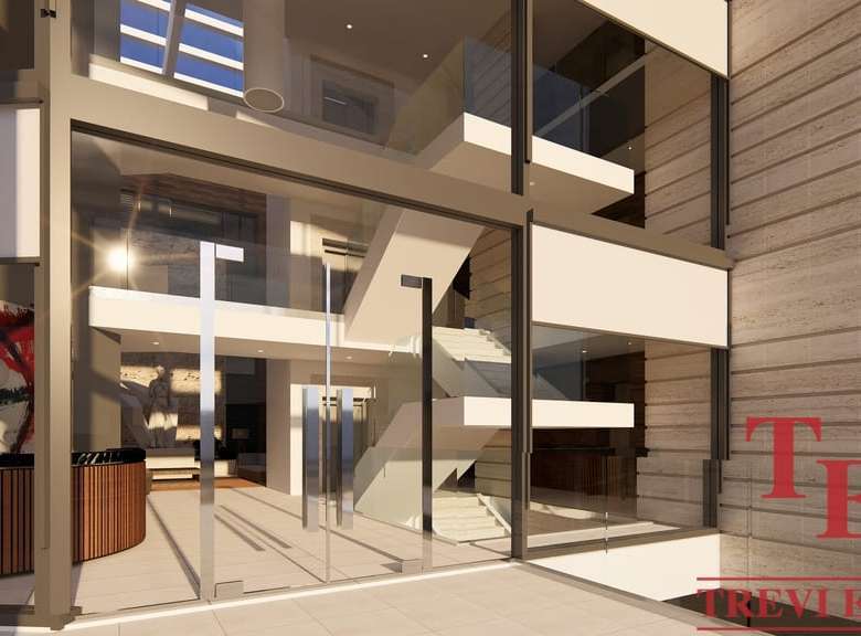 Просторный современный интерьер элитного жилого комплекса с панорамными окнами и стильным дизайном, идеально подходящий для роскошной жизни.