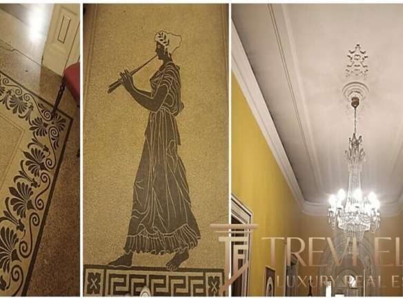 Высококачественный интерьер элитного особняка с изысканным орнаментом и классическими деталями, украшенный хрустальной люстрой и классическими мотивами, подчеркивающими роскошь и элегантность.