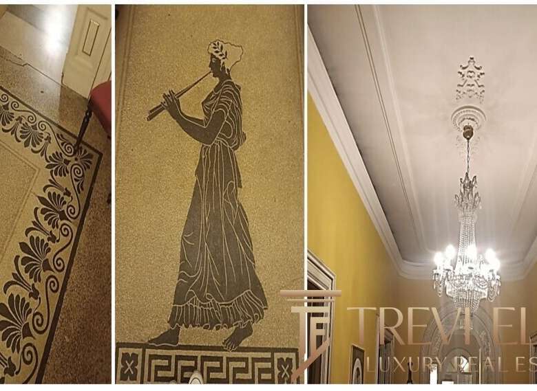 Высококачественный интерьер элитного особняка с изысканным орнаментом и классическими деталями, украшенный хрустальной люстрой и классическими мотивами, подчеркивающими роскошь и элегантность.