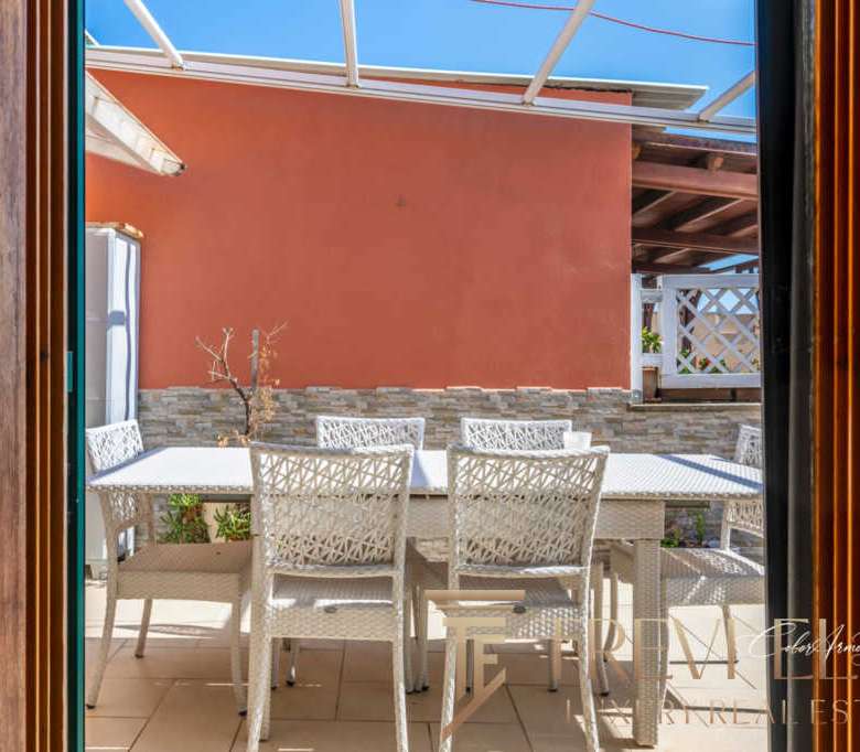 Открытая терраса с современным уютным садовым интерьером и удобной мебелью, идеально подходит для отдыха и уютных вечеров под открытым небом.