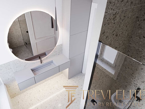 Современный интерьер ванной комнаты с просторной раковиной и круглыми зеркалами, выполненный в светлых оттенках, идеально подходит для элитного жилья.