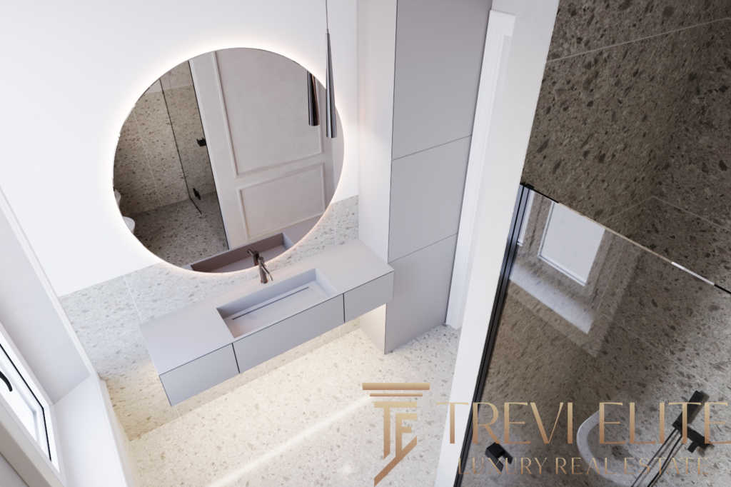 Современный интерьер ванной комнаты с просторной раковиной и круглыми зеркалами, выполненный в светлых оттенках, идеально подходит для элитного жилья.