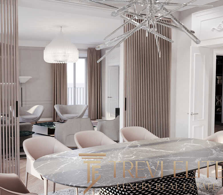 Роскошный современный интерьер жилой квартиры в стиле модерн, с белыми стенами, просторной гостиной, изысканной мебелью и освещением, создающим уютную атмосферу для комфорта и отдыха.