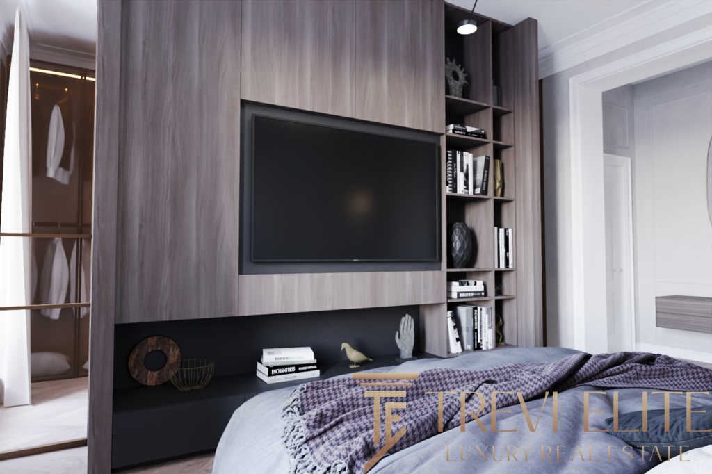 Современная гостиная с встроенным телевизором, элегантной shelving-системой и стильным декором, создающая уютную атмосферу для семейного отдыха и развлечений.