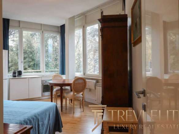 Высококачественное изображение современного интерьера квартиры с панорамными окнами и уютной зоной отдыха, представляется в элитном жилом комплексе для эксклюзивных клиентов.