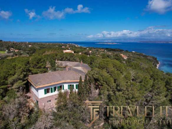 Уединенный особняк на живописном побережье Средиземного моря с видом на океан, окруженный зеленой растительностью, идеально подходит для элитной покупки за границей.