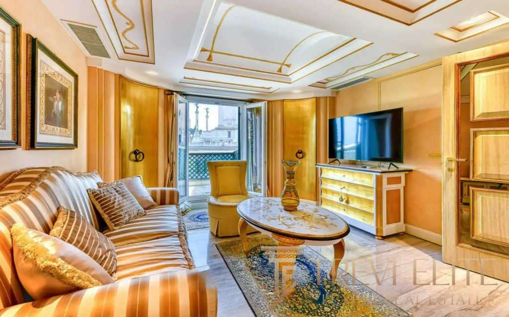 Элитная гостиная с уютным диваном, классическими картинами и балконным доступом, создающая ощущение роскоши и комфорта в эксклюзивных итальянских апартаментах.
