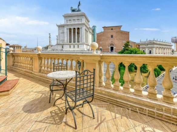 Вид на исторический центр Рима с террасы в стиле классика, украшенной кованой мебелью и римской архитектурой. Идеальное место для отдыха, наслаждения панорамой и роскошной жизни.