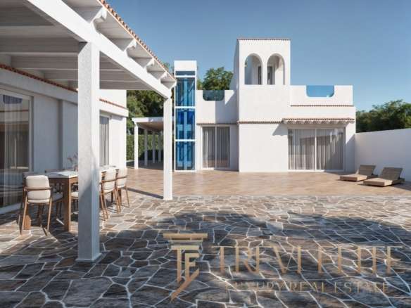 Элегантный вид современной итальянской виллы с просторной террасой, облицованной камнем, белыми стенами и зонами отдыха на открытом воздухе, типичной для элитной недвижимости Треви Элит.