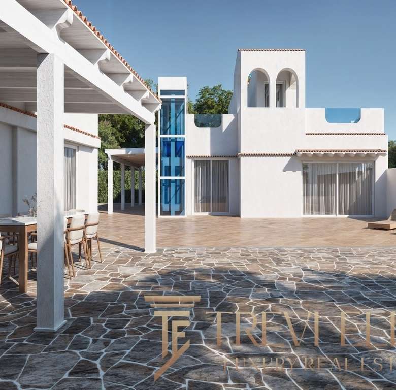 Элегантный вид современной итальянской виллы с просторной террасой, облицованной камнем, белыми стенами и зонами отдыха на открытом воздухе, типичной для элитной недвижимости Треви Элит.