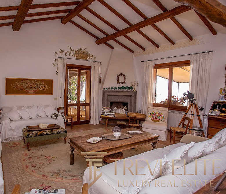 Элитное жилье в стиле шале с деревянными потолочными балками и уютной атмосферой, идеально для ценителей роскоши и комфорта в Италии.