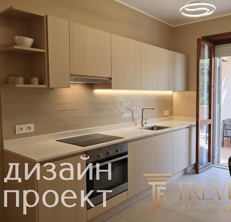 Современная кухня с белыми фасадами и встроенной техникой, выходом на уютную террасу с креслами и видом на зелень, стильное освещение и нейтральные тона интерьера.