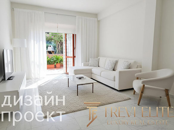 Современная светлая гостиная с белой мебелью и большим окном, выходящим на балкон с зеленью, идеальное решение для уютного домашнего интерьера.