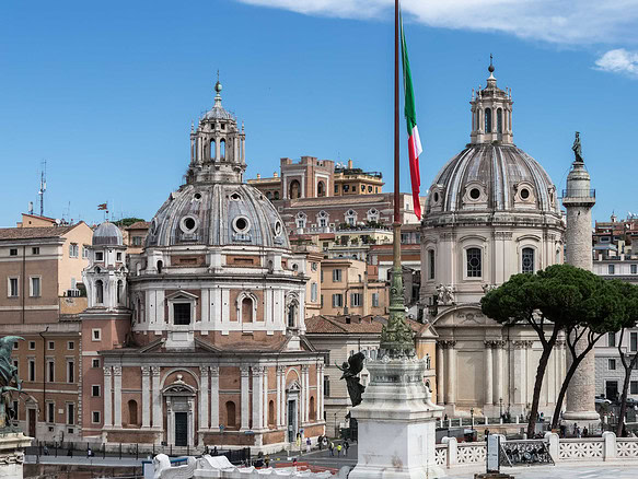 Элегантный архитектурный пейзаж Рима с двумя барочными куполами и итальянским флагом, символизирующим традиции и историю, в центре города.