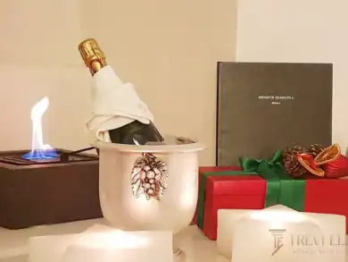 Luxury tabletop styling with champagne, festive gifts, and decorative accessories