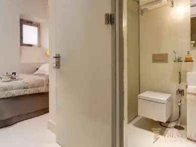 Ensuite bathroom with walk-in shower and dual vanity, adjacent bedroom