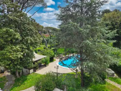 Luxury villa grounds with heated pool and mature landscaping, Lazio