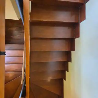 Wooden built-in storage cabinet with open shelves and drawers