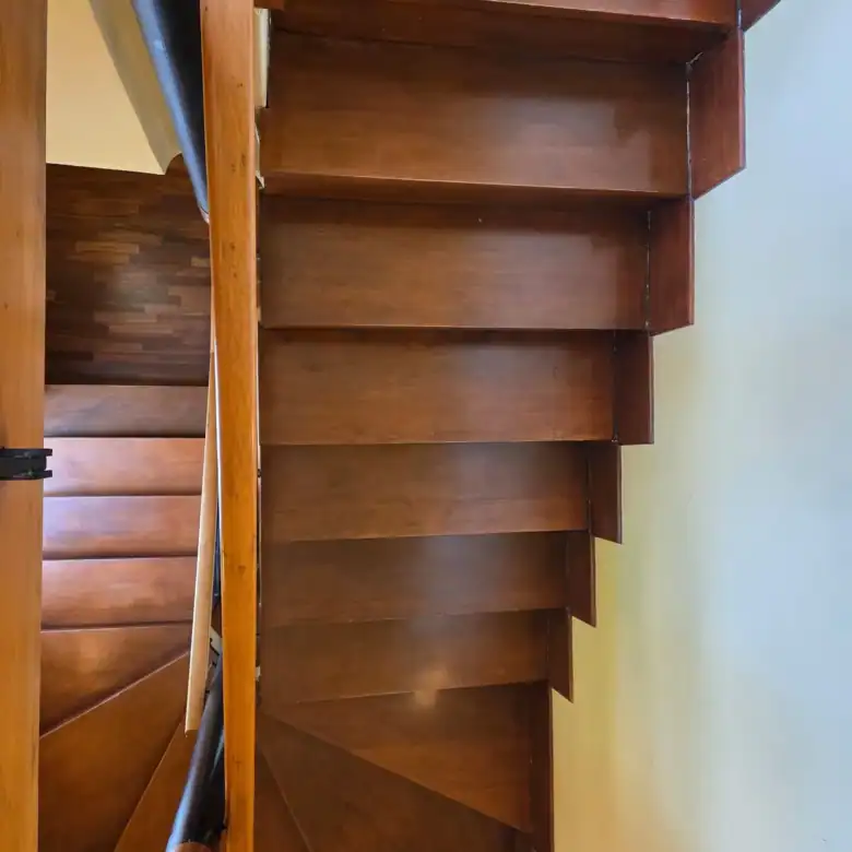 Wooden built-in storage cabinet with open shelves and drawers